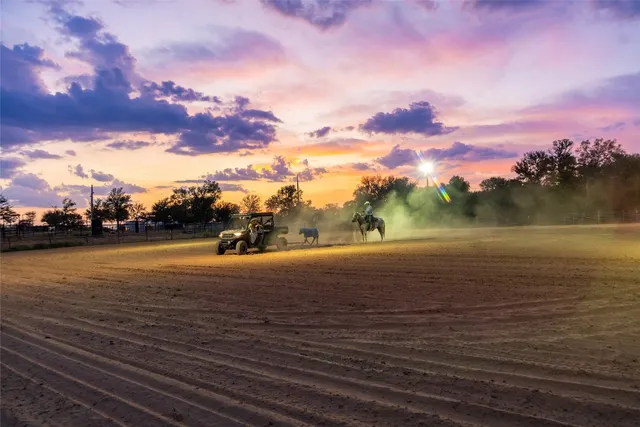 a view of a swimming pool with a yard and sitting area