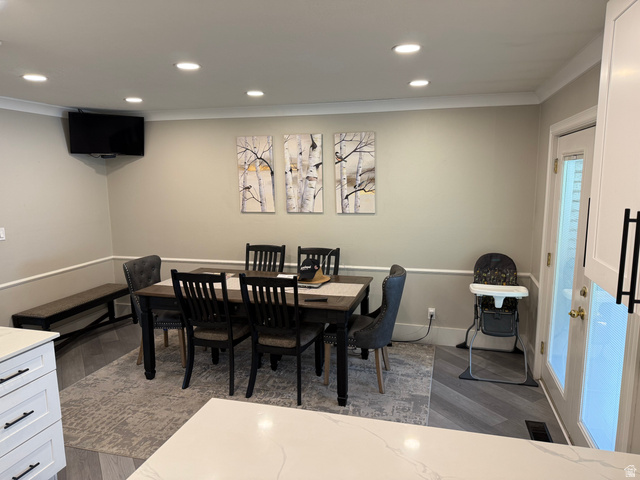 1360 Carterville Road Orem, UT 84097 - Photo 4 of 41 Recessed ceiling lighting, crown molding, chair rail molding, wood-finish flooring, and a built-in bench