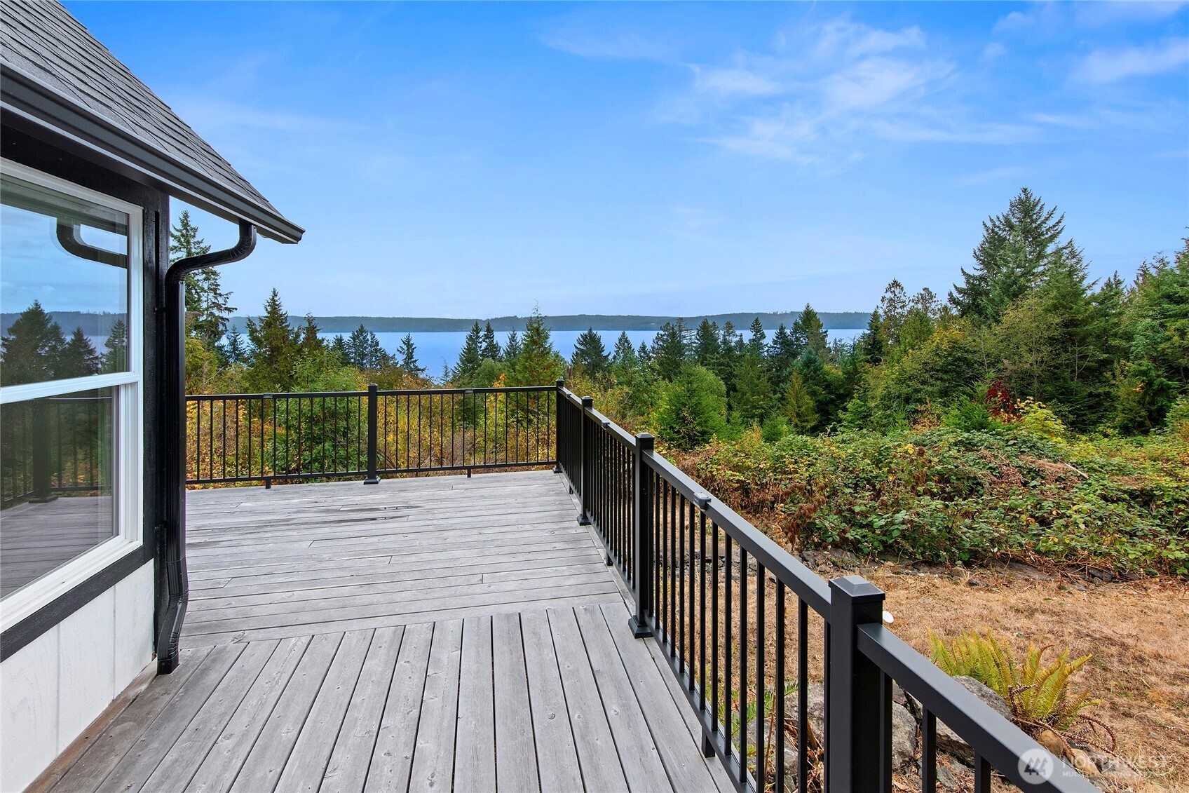 304292 Highway 101 Brinnon, WA 98320 - Photo 18 of 33 a view of a balcony with wooden floor and fence next to a yard