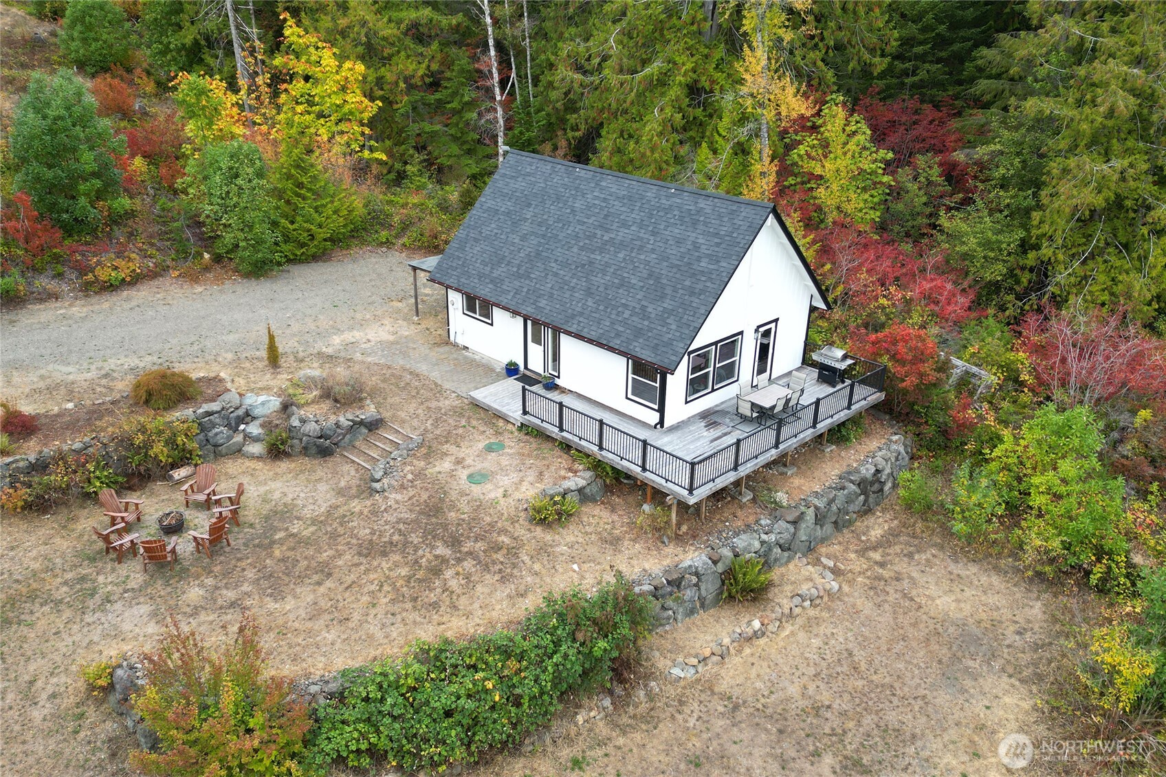 304292 Highway 101 Brinnon, WA 98320 - Photo 2 of 33 a aerial view of a house with a yard and large tree