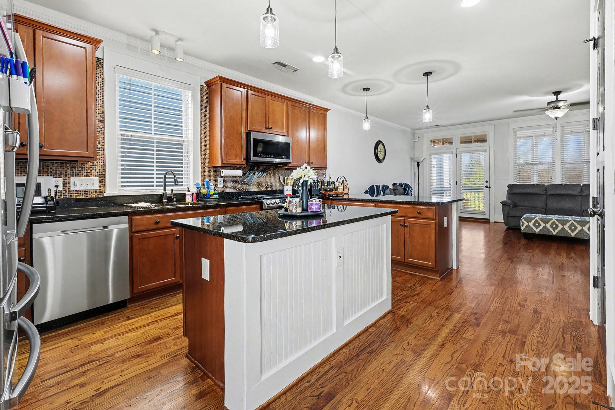 797 Herrons Ferry Road Rock Hill, SC 29730 - Photo 12 of 34 a kitchen with stainless steel appliances granite countertop a sink stove and wooden floor