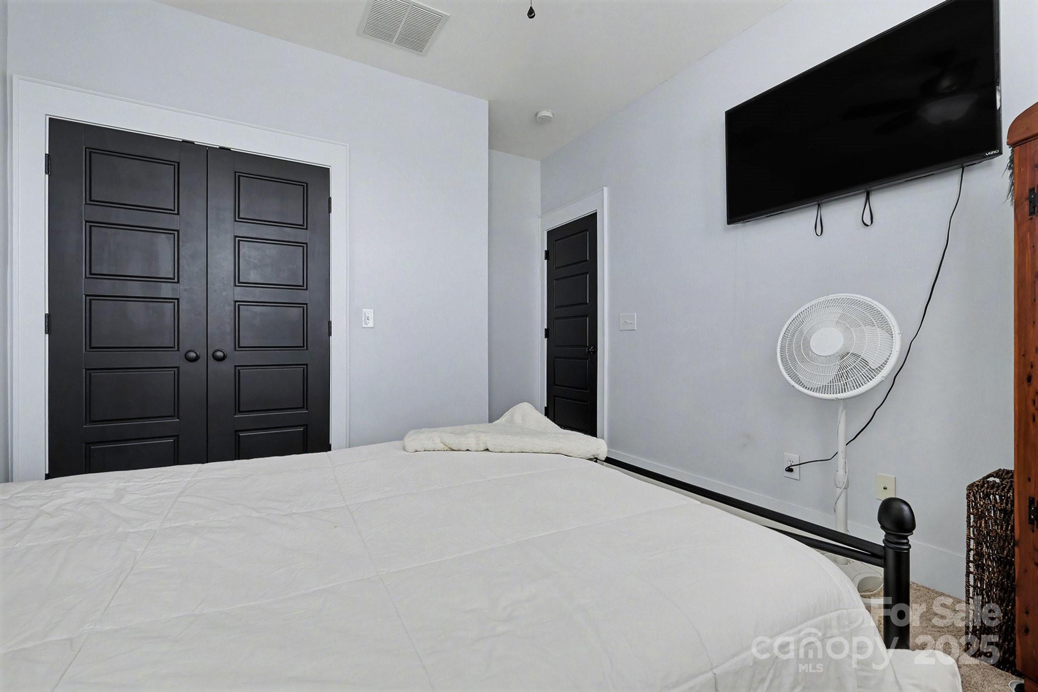 797 Herrons Ferry Road Rock Hill, SC 29730 - Photo 17 of 34 a bedroom with a bed and a flat screen tv