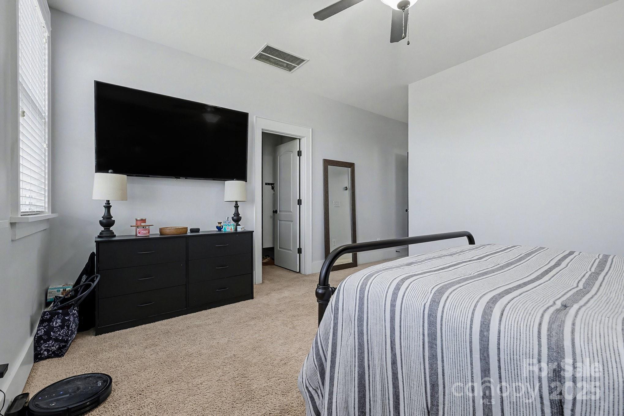 797 Herrons Ferry Road Rock Hill, SC 29730 - Photo 23 of 34 a bedroom with a bed and a flat tv screen