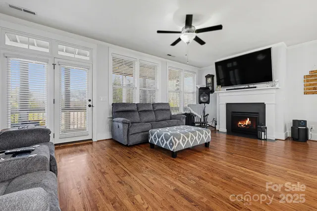 a living room with furniture fireplace and flat screen tv