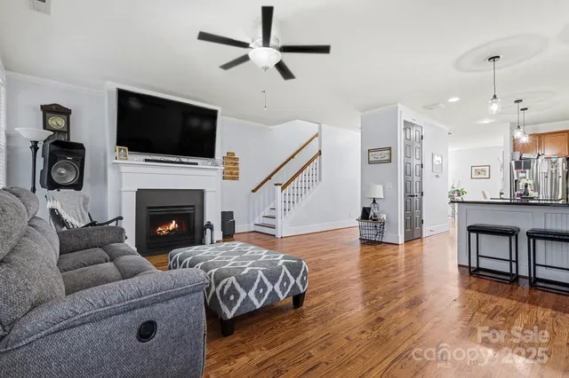 a living room with furniture fireplace and flat screen tv