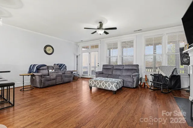 a living room with furniture and a wooden floor