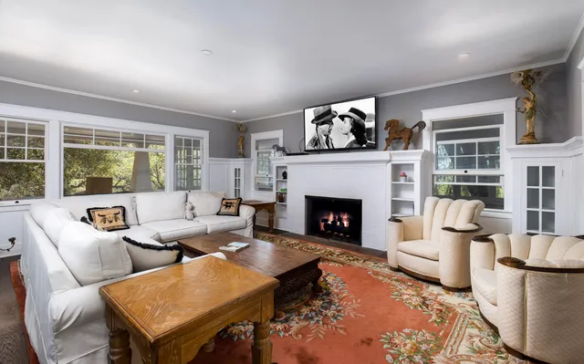 a kitchen with a refrigerator a stove a sink and chairs