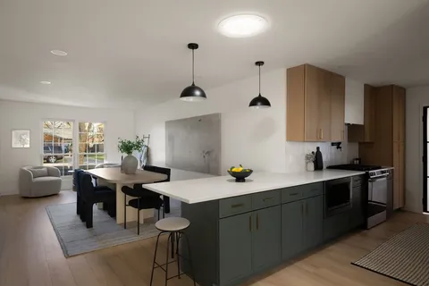 a kitchen with a table chairs stove and microwave