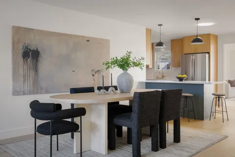 a view of a dining room with furniture and window