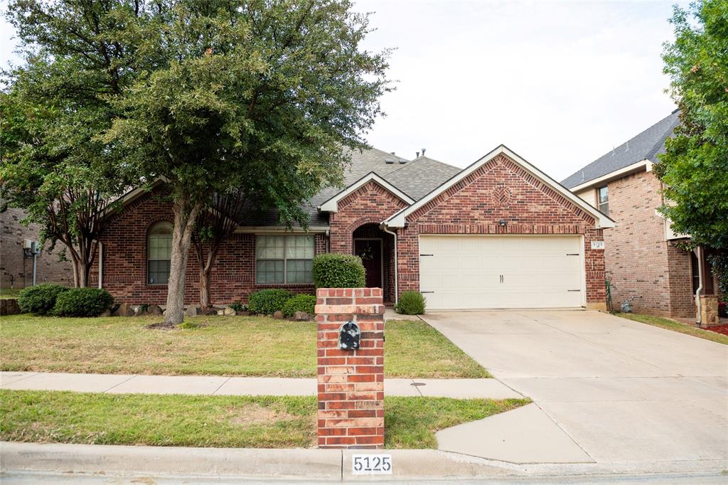 5125 Shelly Ray Road Fort Worth, TX 76244 - Photo 1 of 1 Ranch-style home with a shingled roof, a front yard, concrete driveway, brick siding, and a garage