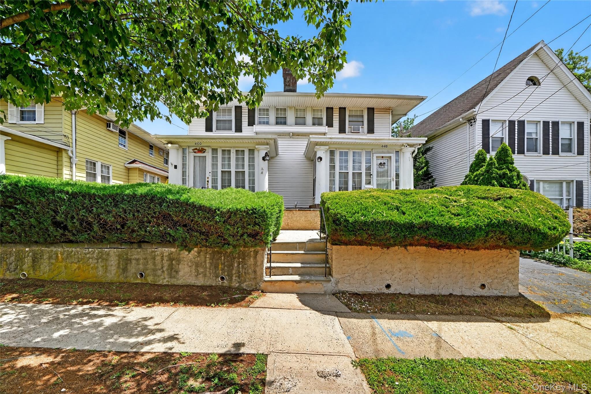 448 First Avenue Pelham, NY 10803 - Photo 1 of 1 a front view of a house with a garden and lake view