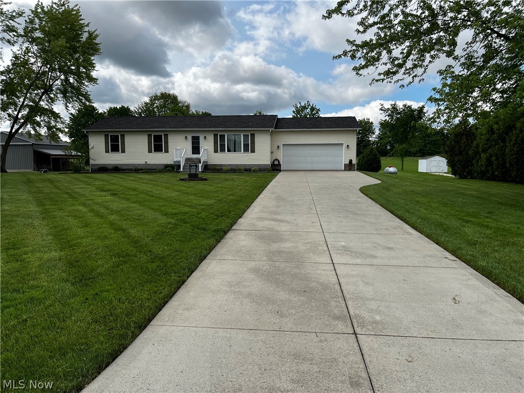 6876 Clark Road Atwater, OH 44201 - Photo 38 of 41 Ranch-style home featuring a front yard and a garage