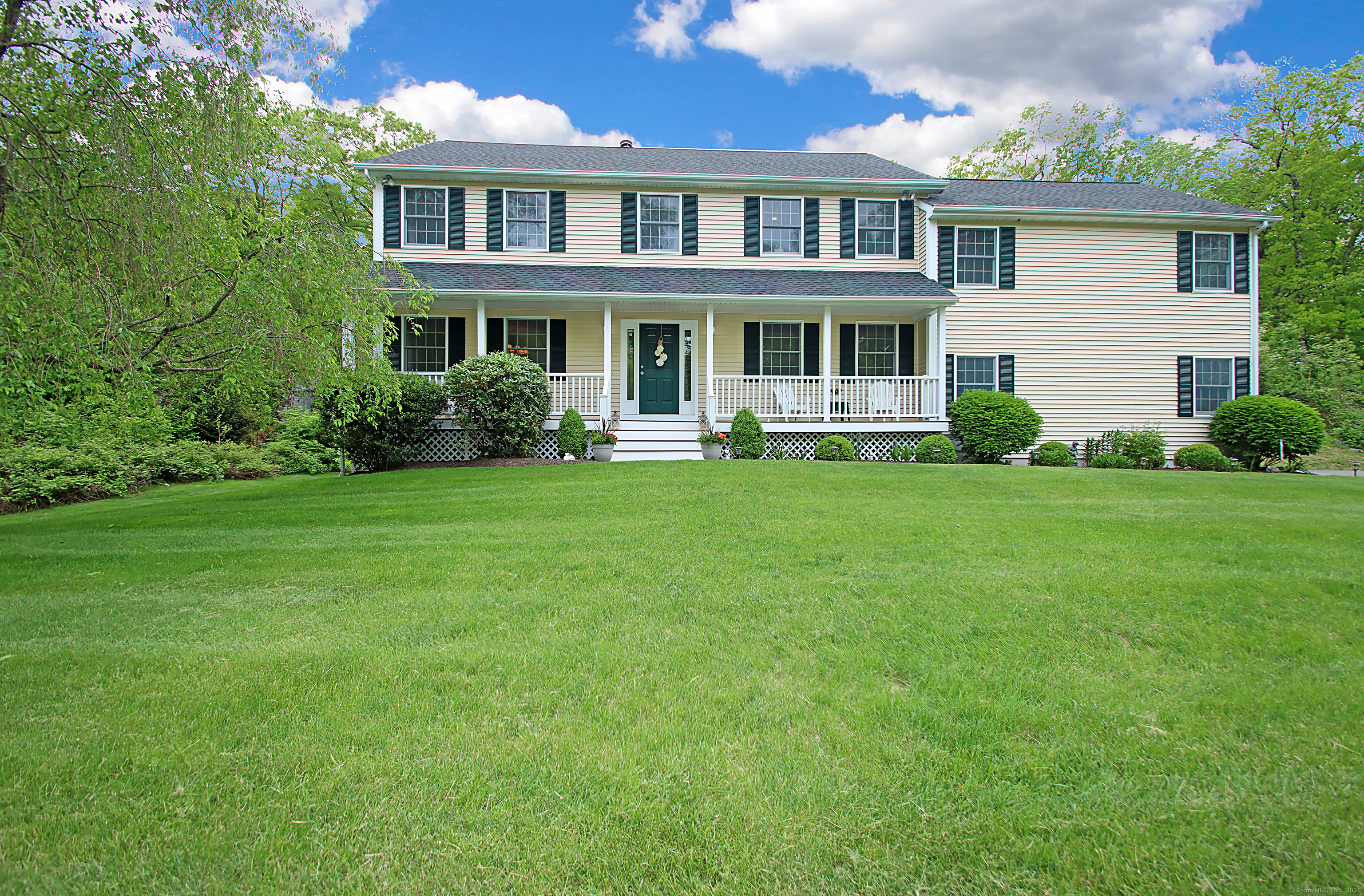 a front view of a house with a garden and porch