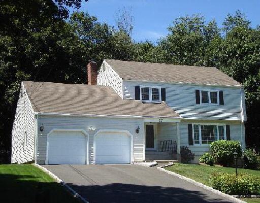 27 Jamestown Road Trumbull, CT 06611 - Photo 1 of 1 a view of a white house with a yard plants and large tree