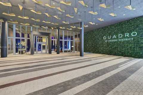 a view of lobby with a tv and glass door