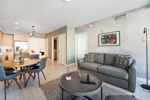 a kitchen with stainless steel appliances a sink a refrigerator and a stove