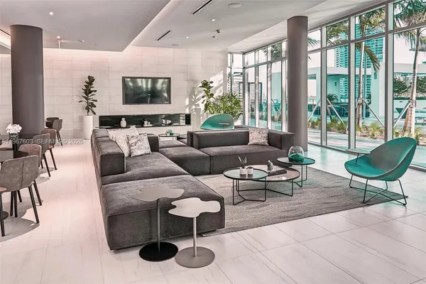 a living room with furniture and a potted plant