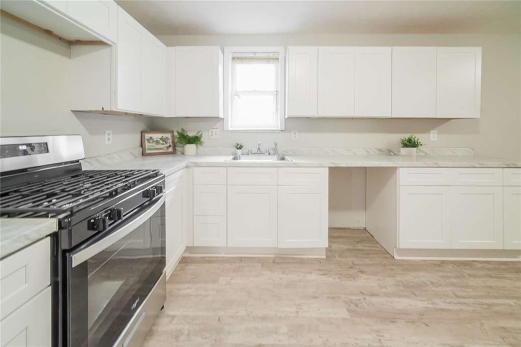 658 Agan Road Bremen, GA 30110 - Photo 4 of 15 a kitchen with cabinets appliances and a sink