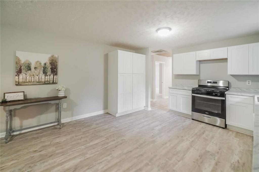 658 Agan Road Bremen, GA 30110 - Photo 5 of 15 a kitchen with a refrigerator and a stove top oven