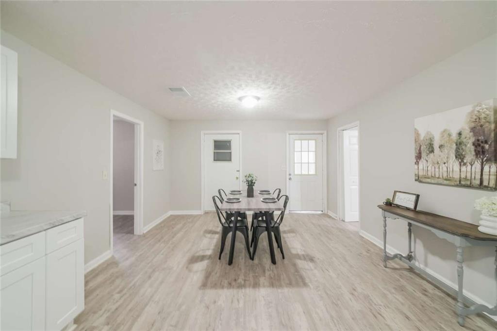 658 Agan Road Bremen, GA 30110 - Photo 6 of 15 a view of a dining room with furniture and wooden floor