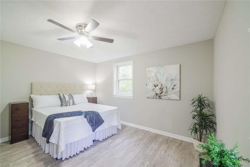 658 Agan Road Bremen, GA 30110 - Photo 8 of 15 a bedroom with a large bed and a chandelier