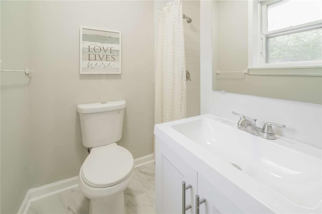 658 Agan Road Bremen, GA 30110 - Photo 9 of 15 a bathroom with a toilet sink and mirror