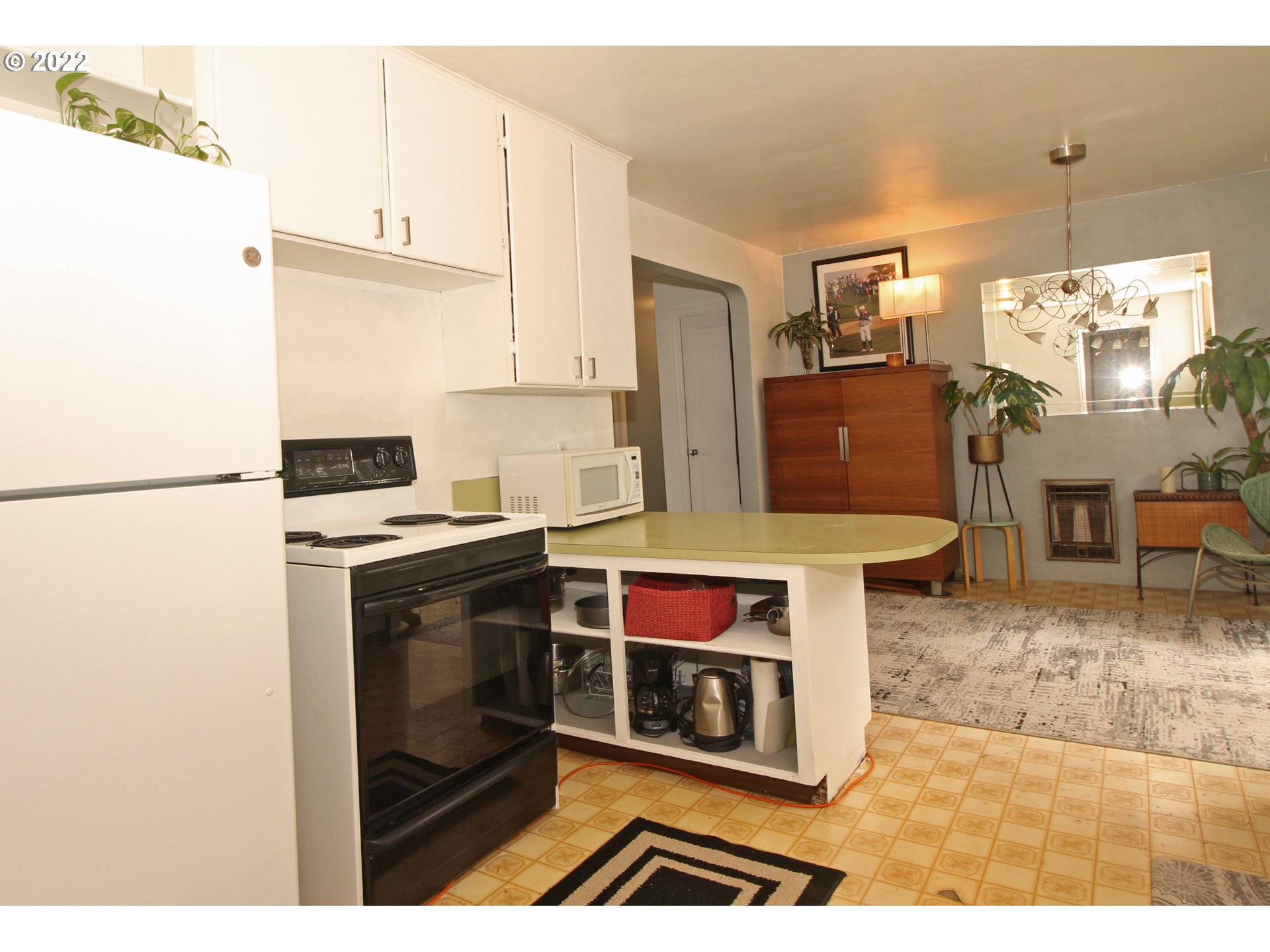 1939 E Street Springfield, OR 97477 - Photo 12 of 32 a kitchen with a stove a refrigerator and cabinets