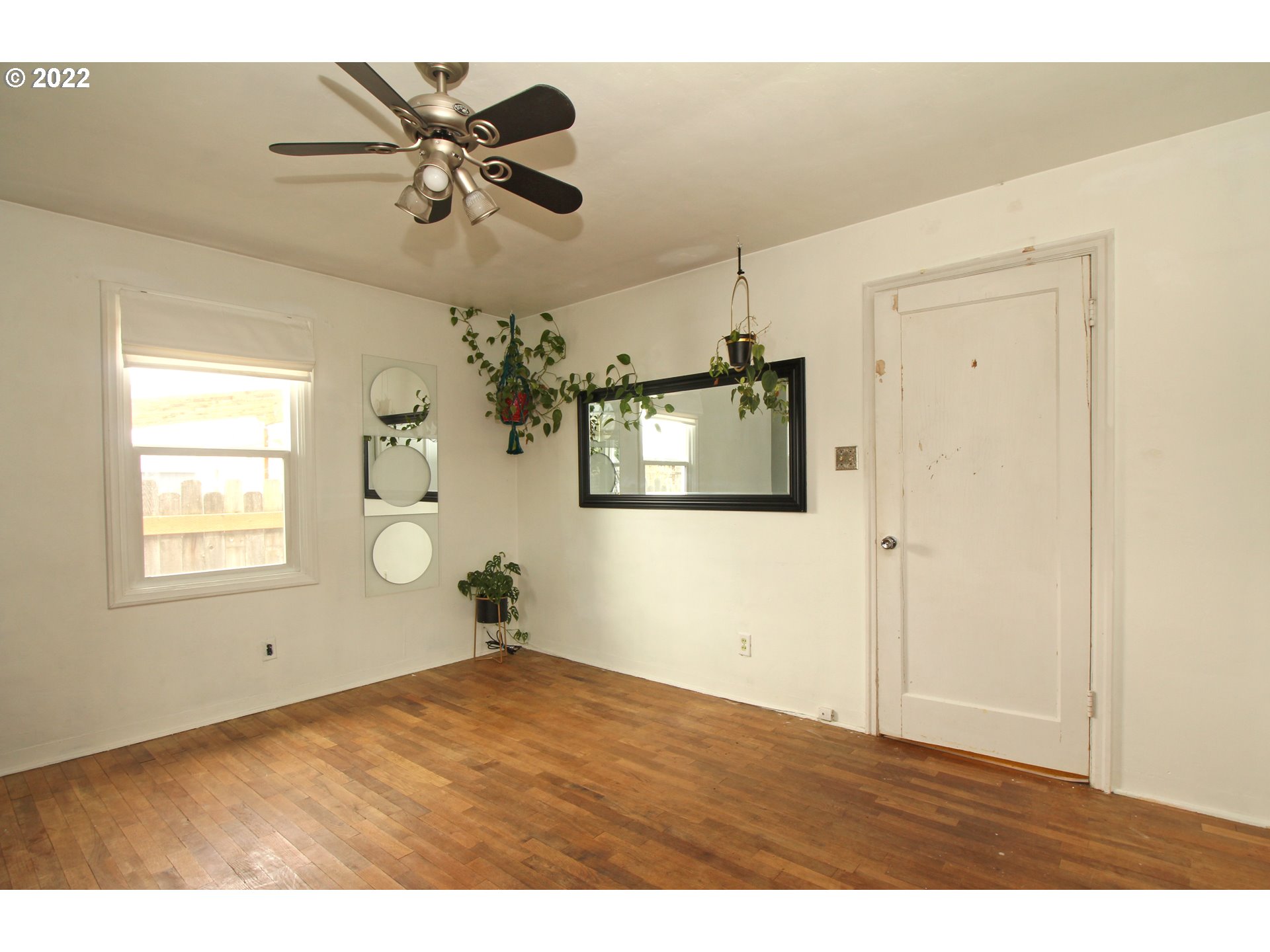 1939 E Street Springfield, OR 97477 - Photo 19 of 32 a view of empty room with wooden floor and ceiling fan