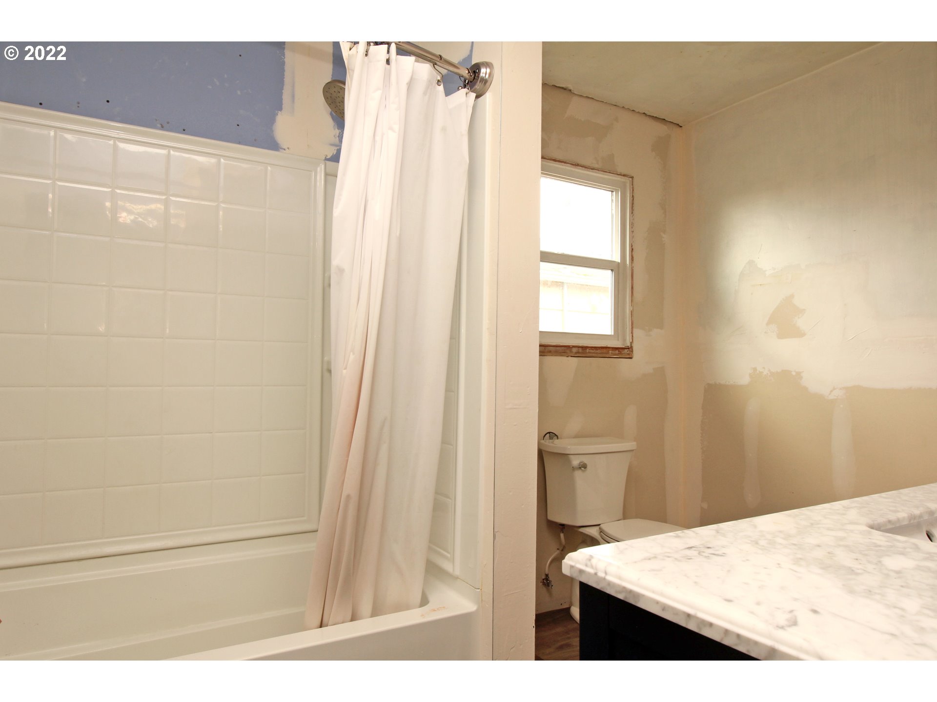 1939 E Street Springfield, OR 97477 - Photo 21 of 32 a bathroom with a shower curtain and a sink