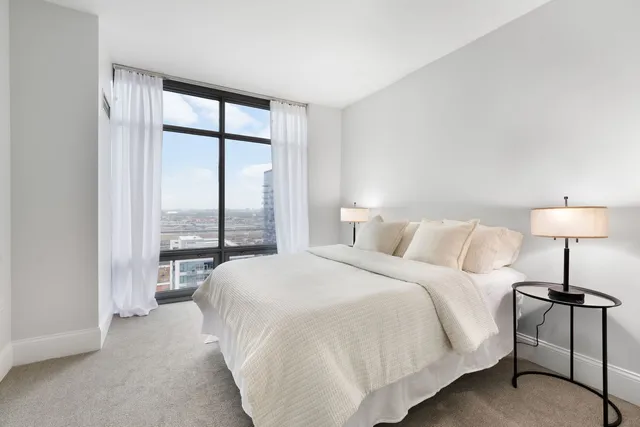 a bedroom with a bed and a lamp