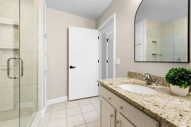 a bathroom with a granite countertop sink and a mirror