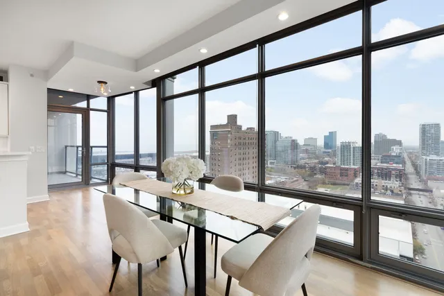 a view of a dining room with furniture large windows and wooden floor