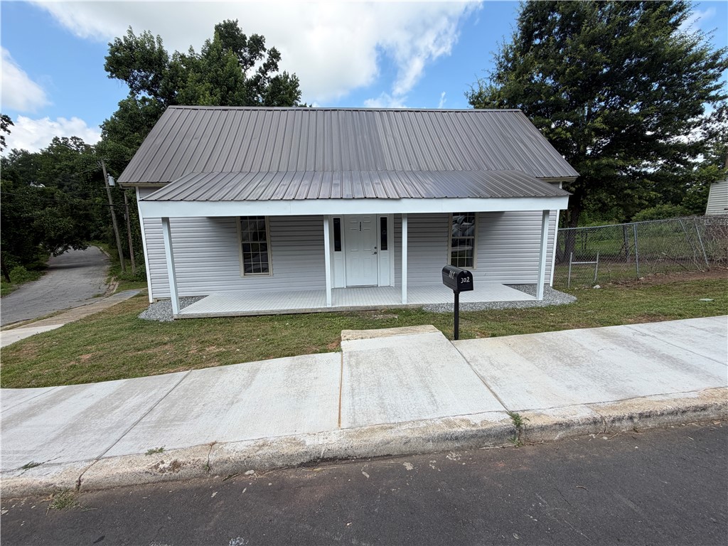 302 Sirrine Street Honea Path, SC 29654 - Photo 2 of 24 A charming exterior with a new metal roof and inviting front porch awaits.