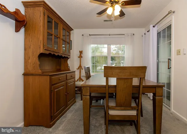 a kitchen with a refrigerator and a table