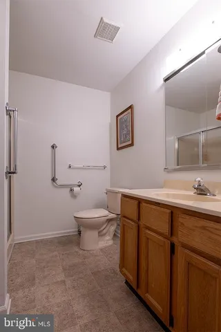 a bathroom with a toilet a sink and mirror