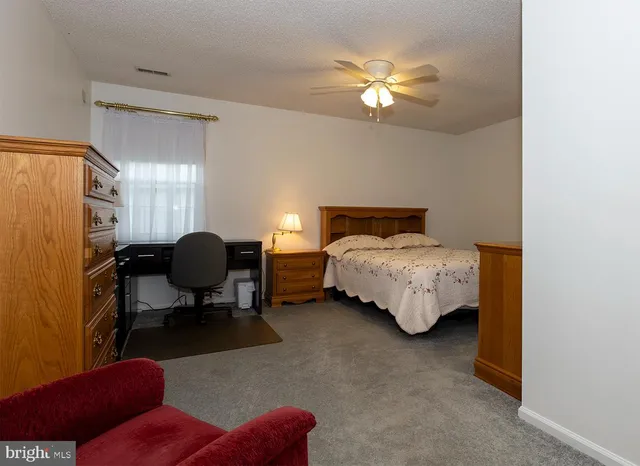 a bedroom with bed and a chandelier
