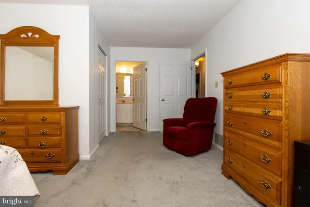 wooden floor in closet and a couch