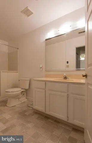 a bathroom with a sink toilet and mirror
