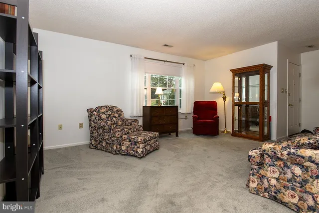 a living room with furniture window and a dresser