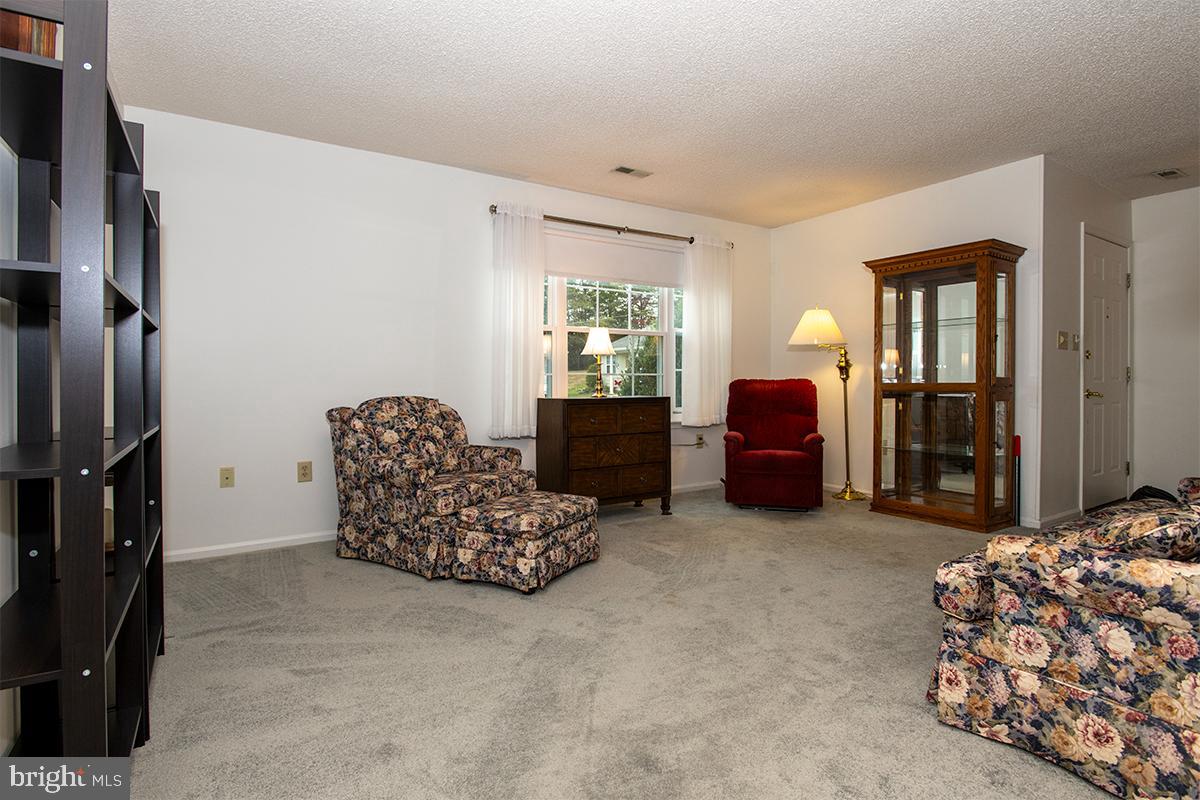 2000 Miller Avenue, Unit 26 Millville, NJ 08332 - Photo 7 of 25 a living room with furniture window and a dresser