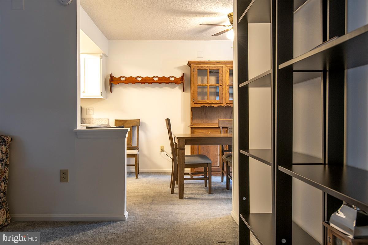 2000 Miller Avenue, Unit 26 Millville, NJ 08332 - Photo 10 of 25 a kitchen with a refrigerator and table chairs