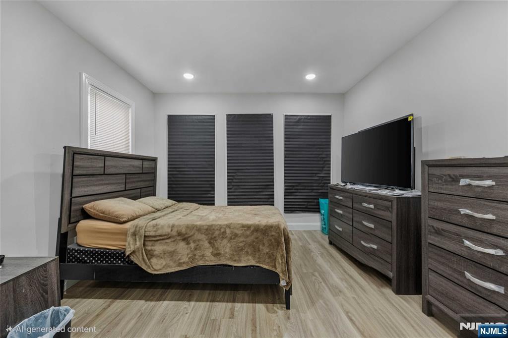 81 Wolcott Terrace Newark, NJ 07112 - Photo 12 of 20 a bedroom with a bed and a flat screen tv