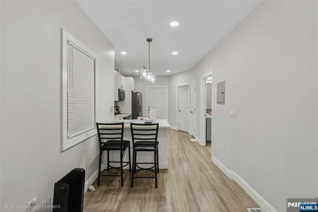 a view of a a dining room with furniture and wooden floor