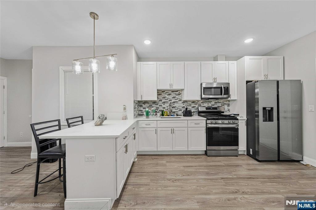 81 Wolcott Terrace Newark, NJ 07112 - Photo 7 of 20 a kitchen with kitchen island a sink appliances and cabinets