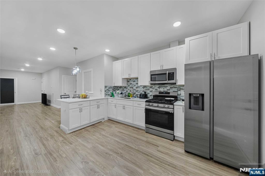 81 Wolcott Terrace Newark, NJ 07112 - Photo 10 of 20 a large kitchen with a refrigerator a stove top oven a sink and dishwasher with wooden floor