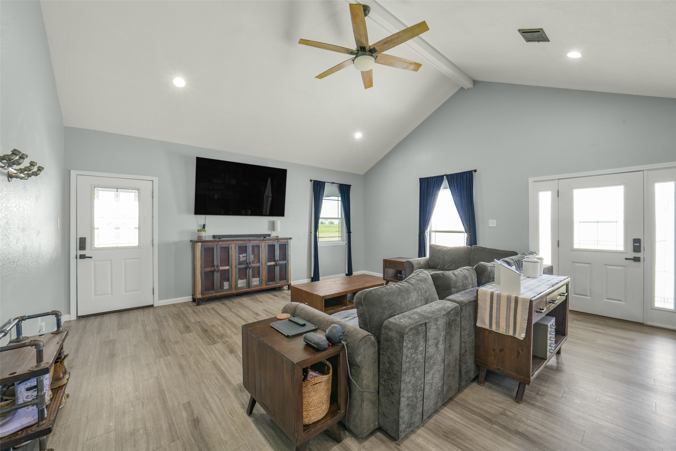 11301 South FM 441 Road El Campo, TX 77437 - Photo 13 of 43 This inviting living room features high vaulted ceilings, a ceiling fan, and ample natural light.