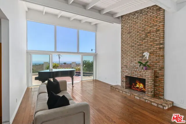 a living room with furniture wooden floor and a fireplace