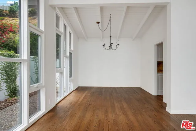 a view of a room with wooden floor fence and windows