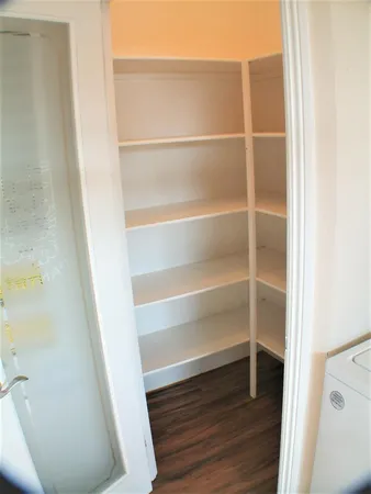 a view of walk in closet with empty racks