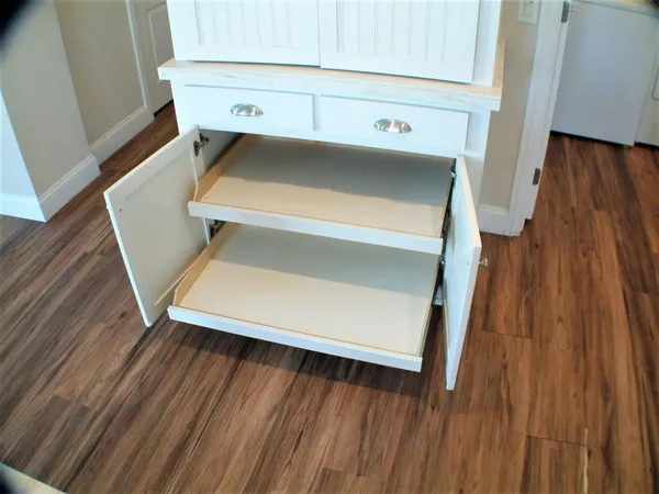 a utility room with wooden floor washer and dryer